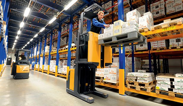 Narrow aisle electric lift trucks working in a warehouse