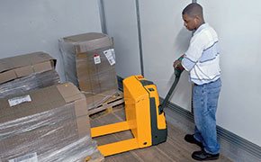 Worker using Jungheinrich electric pallet jack