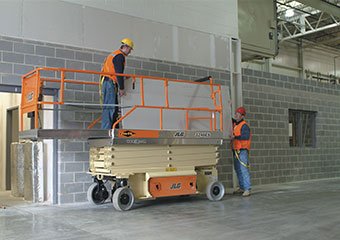 JLG electric scissor lift working in a building