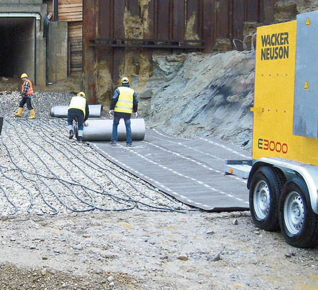 Workers setting up Wacker Neuson ground heaters