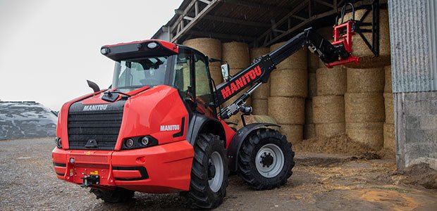 Manitou compact wheel loader hauling hay