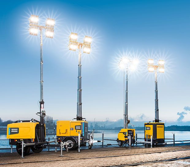 A variety of portable light towers light up a port