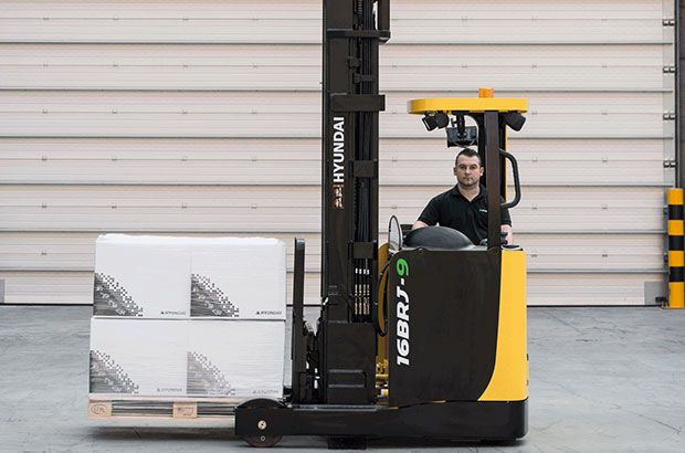 Worker using a BRJ-9 reach truck working in a warehouse