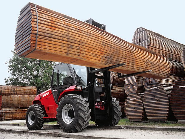 Manitou rough terrain forklift hauling lumber