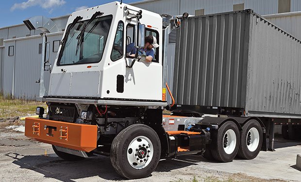 Shunt trucking backing up to a warehouse