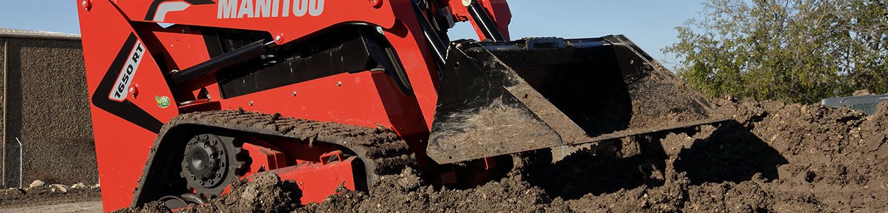 Manitou track loader driving in dirt