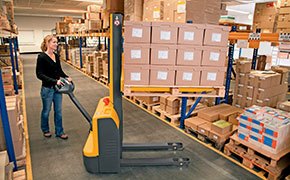 Worker using a Jungheinrich walkie stacker in a warehouse