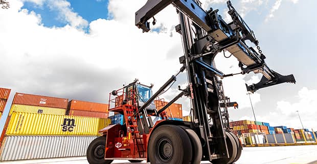 Container handler with replaced parts working with shipping containers