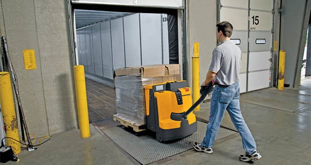 Electric pallet jack with replaced parts being pushed by a person