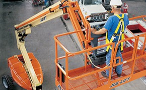 JLG boom lift rental lifting a worker