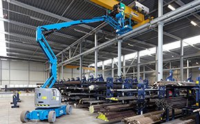 Genie electric boom lift working in a building