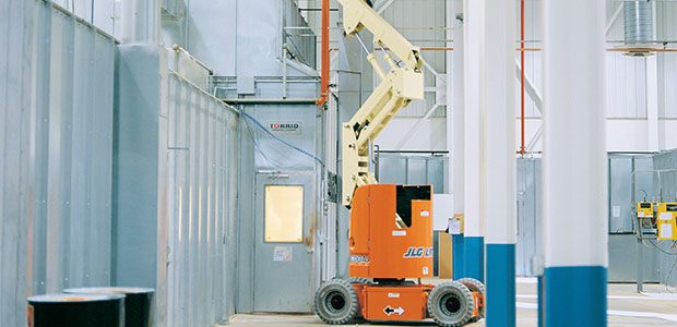 Rental of an electric boom lift working in a warehouse