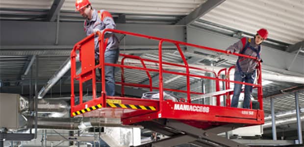 Rented scissor lift working in a warehouse