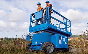 Two workers on a serviced scissor lift