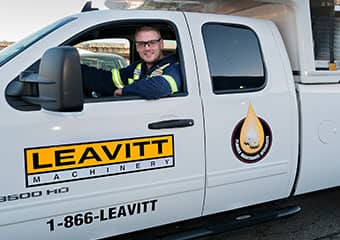 Service worker driving in his truck to do maintenance