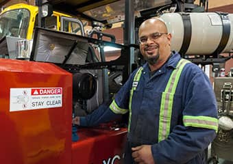 Service worker doing total maintenance on a forklift