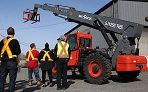 Operators training to use a telehandler