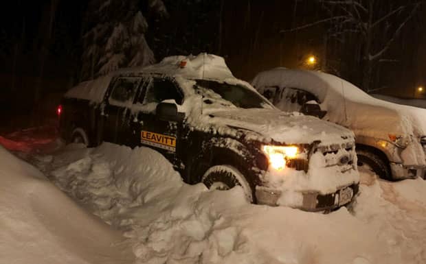 Leavitt truck that is covered in a winter snow storm