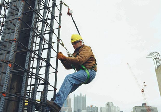Worker doing fall protection training at a worksite