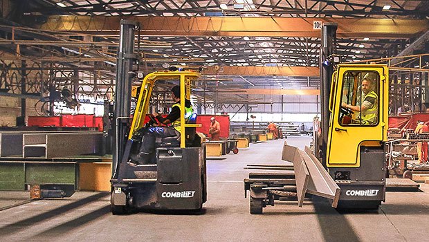 Workers that have been trained on Combilift forklifts working in a warehouse