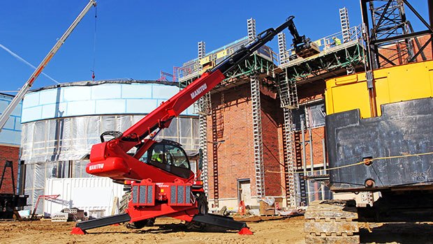 Operator training at a construction site for a Manitou rotating telehandler