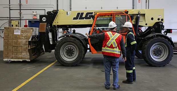 Workers doing a operator training on a telehandler
