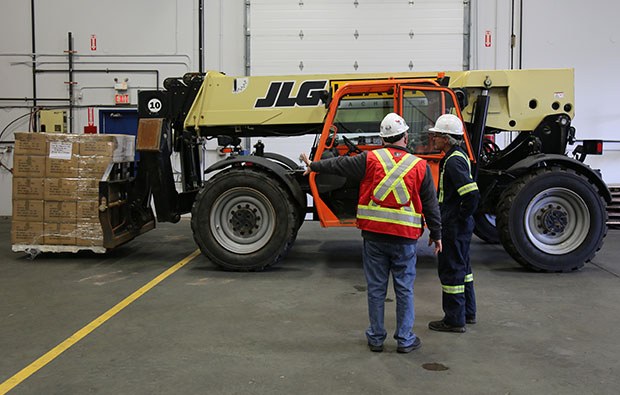 Workers doing operator training zoom boom