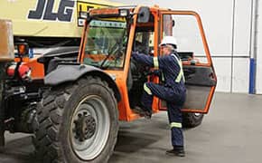 Operator climbing into a Zoom Boom